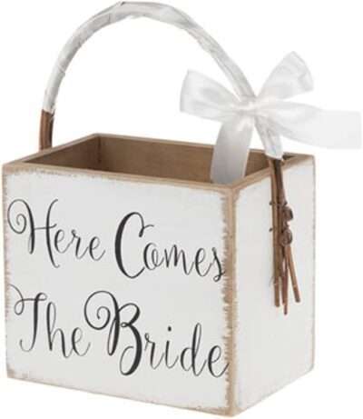 Make your day extra special and sweet with Here Comes The Bride Wood Basket. Made of MDF wood, this darling box basket offers a painted white finish, "here comes the bride" in black text, and a satin ribbon wrapped around the vine handle. Fill it with flower petals for your sweet little flower girl to walk down the aisle with!
