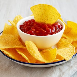 Homemade Salsa and Tortilla Chips on a Plate, side view.