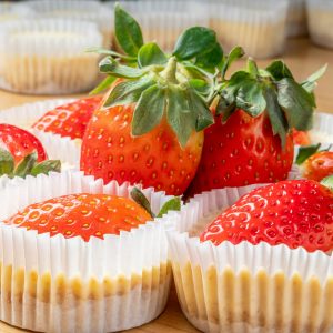 Closeup of the mini strawberry cheesecakes on the wooden table